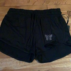 Cute black shorts with a little sliver butterfly.